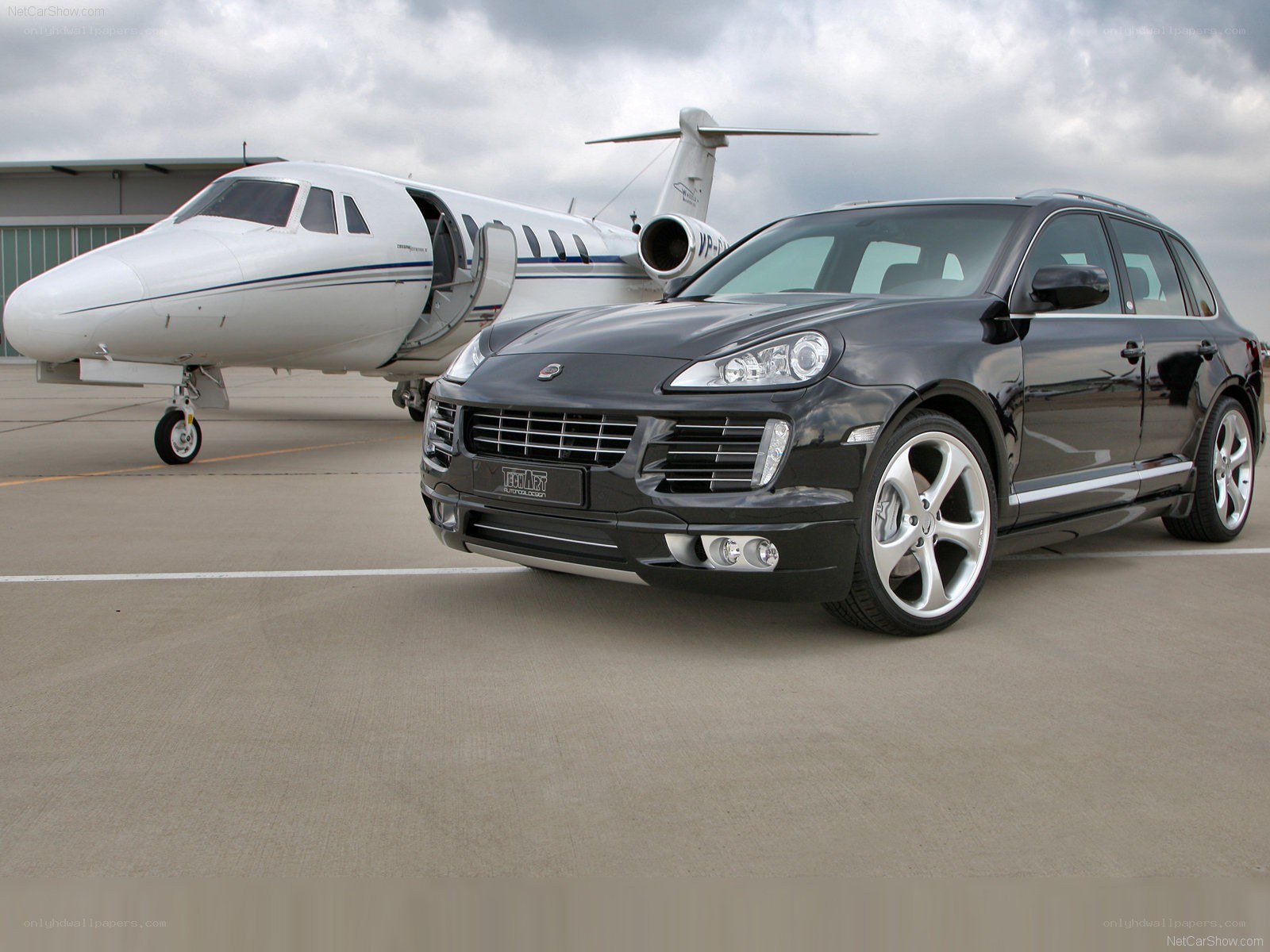 Black Porsche Cayenne with private jet