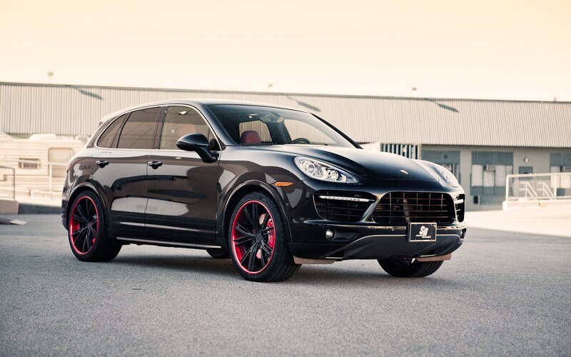Black Porsche Cayenne with red wheels