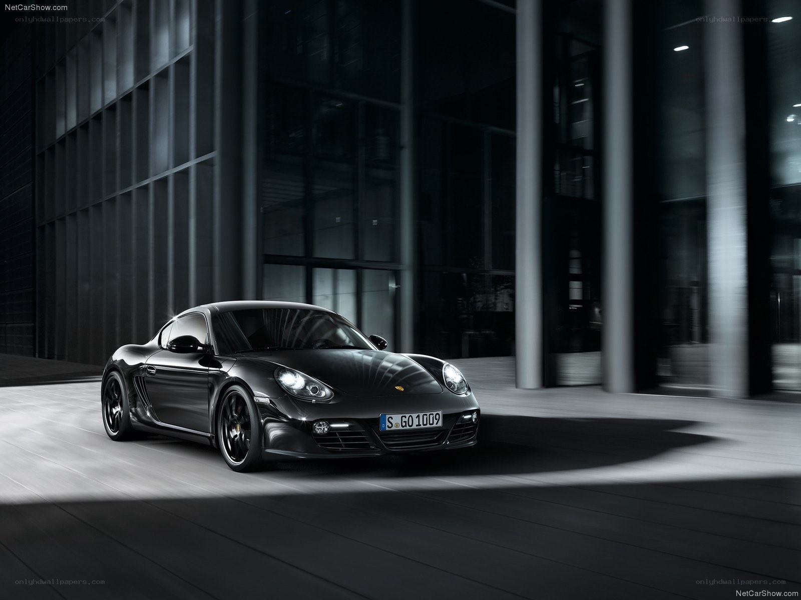 Black Porsche Cayman in modern setting
