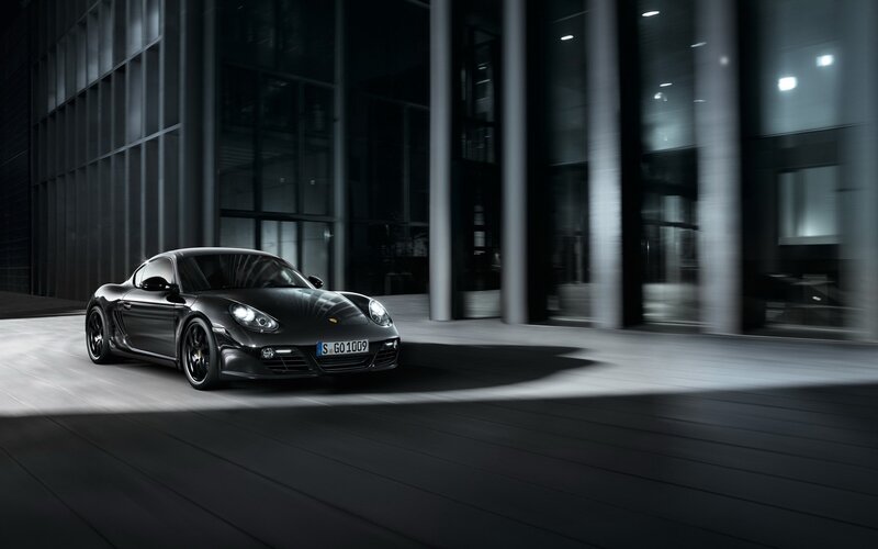 Black Porsche Cayman in modern setting