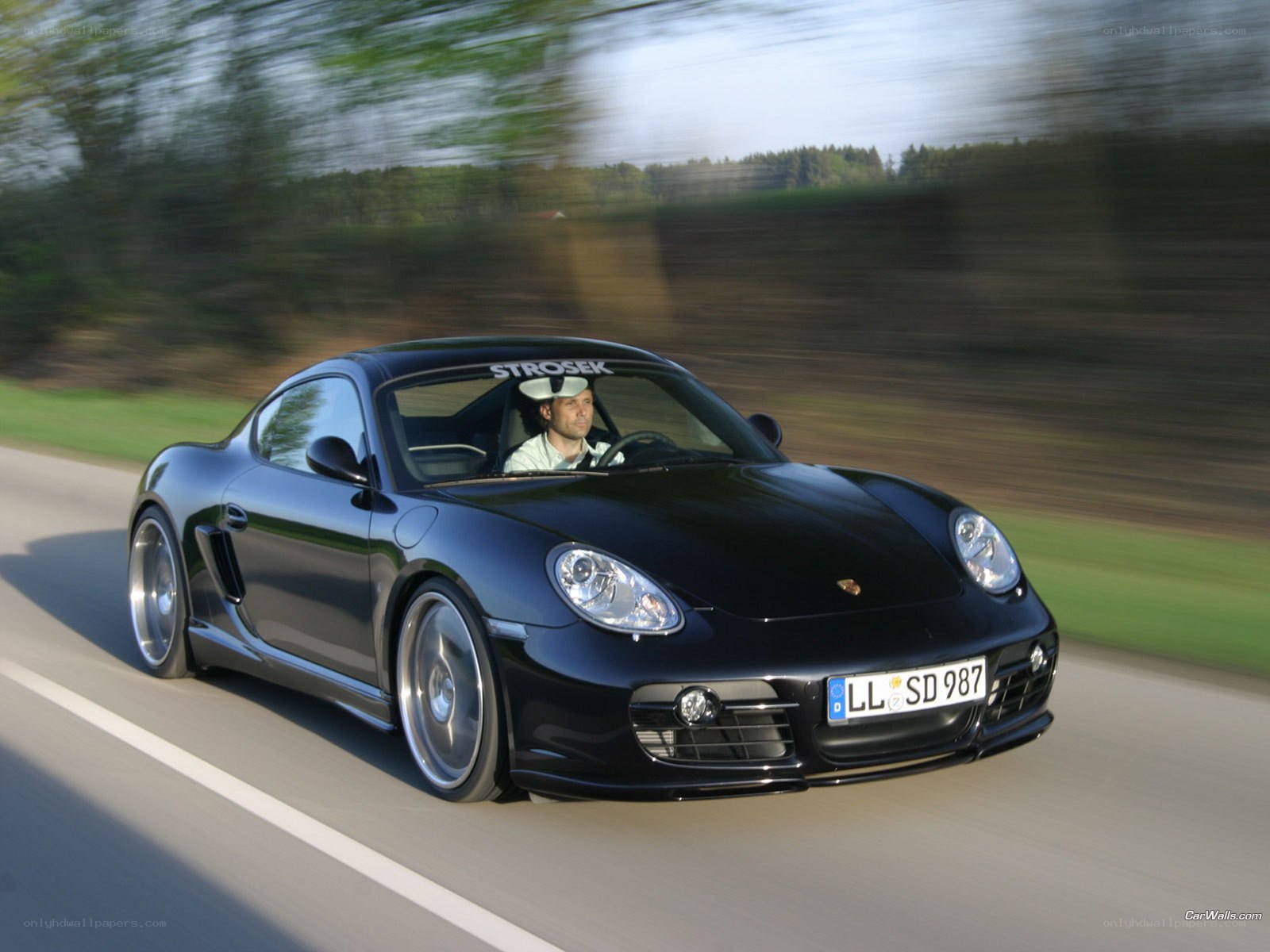 Black Porsche Cayman in motion