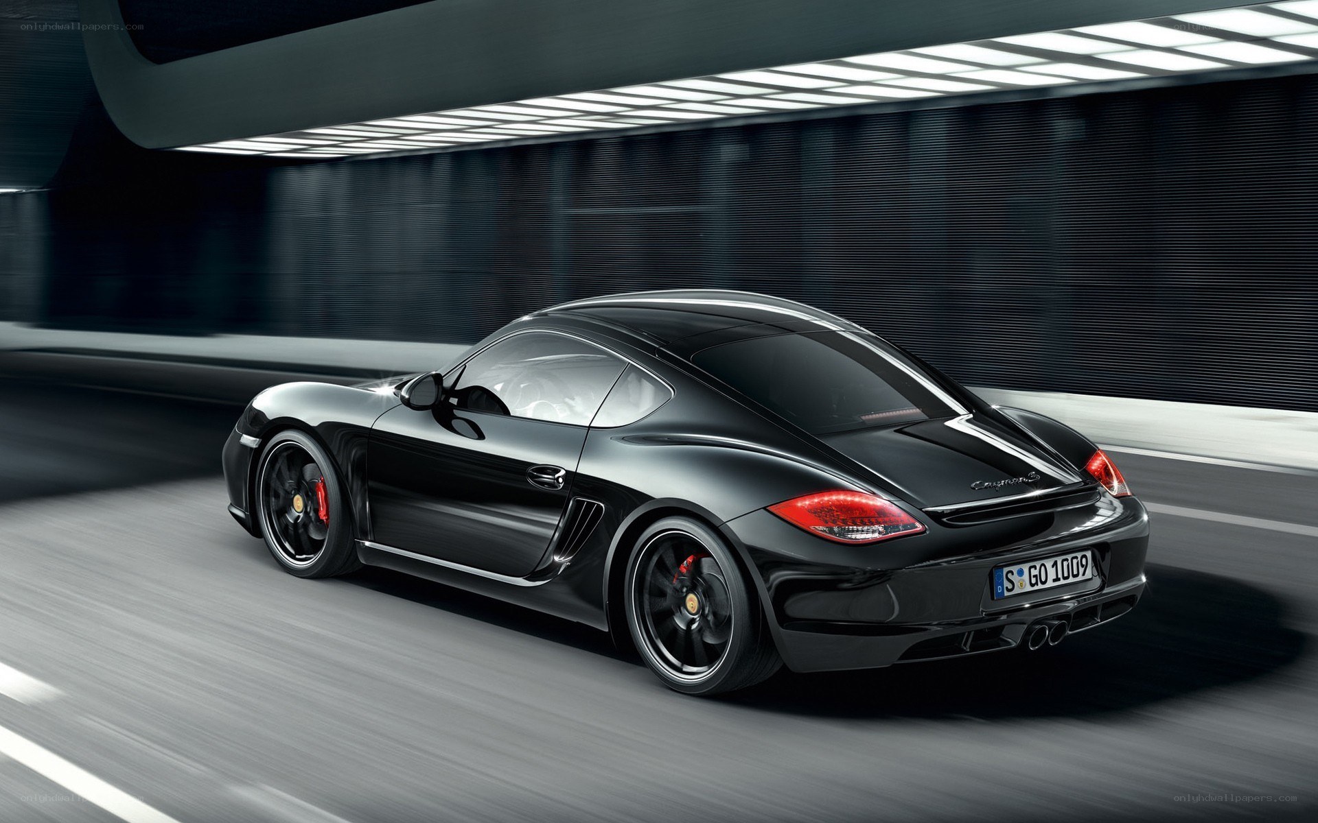 Black Porsche Cayman in motion
