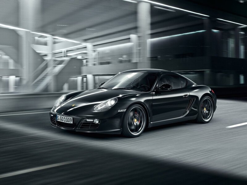 Black Porsche Cayman in motion