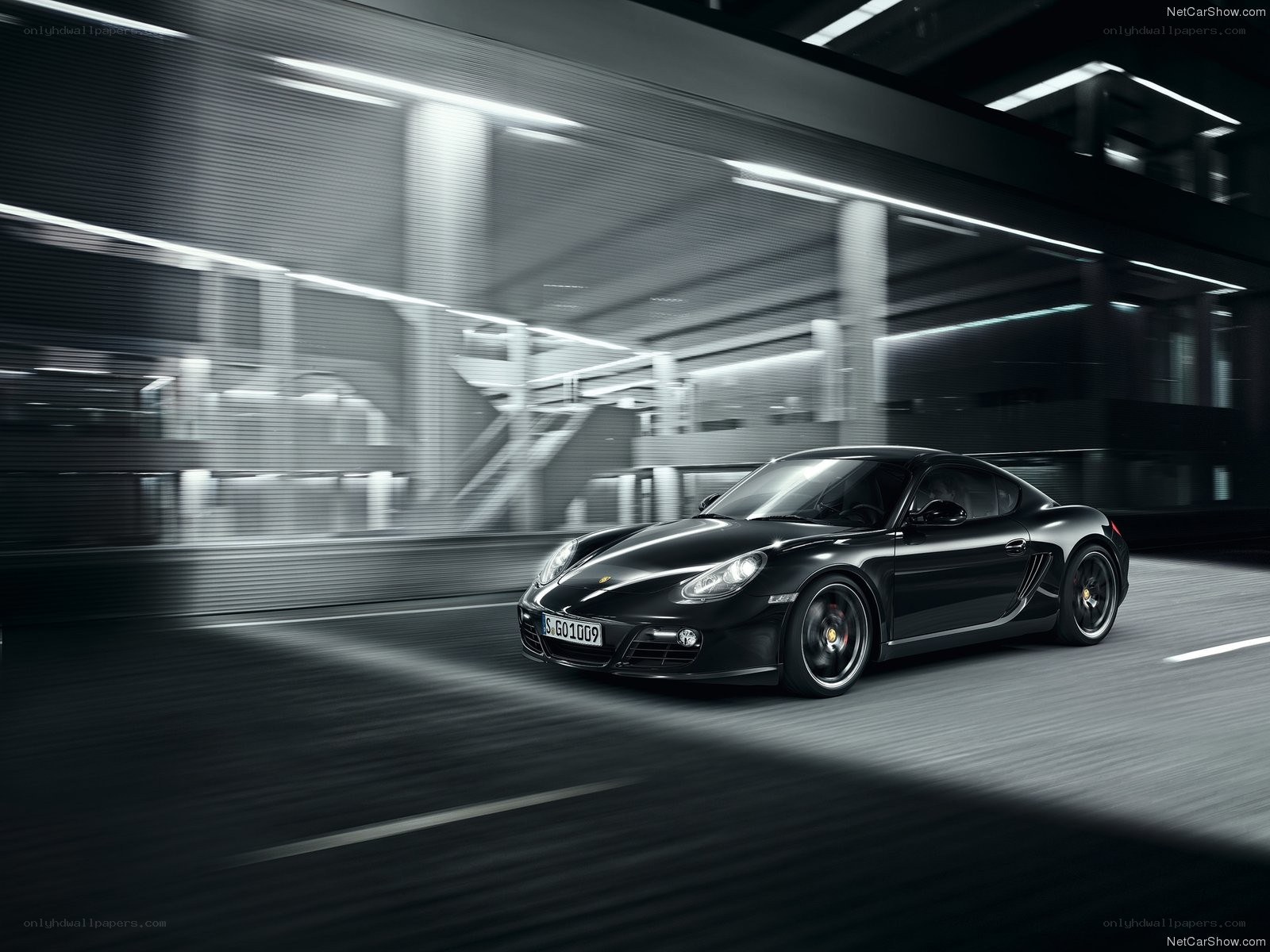 Black Porsche Cayman in motion