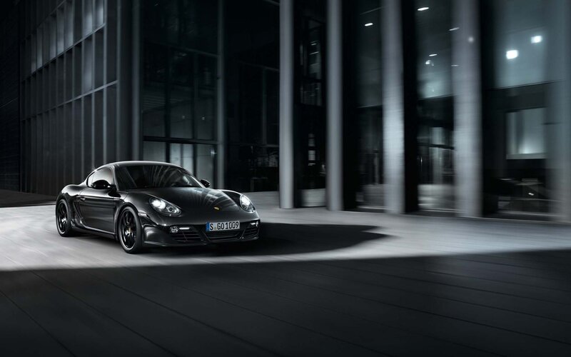 Black Porsche Cayman in urban setting