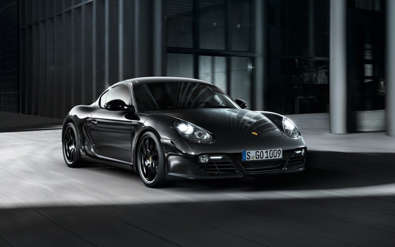 Black Porsche Cayman in urban setting