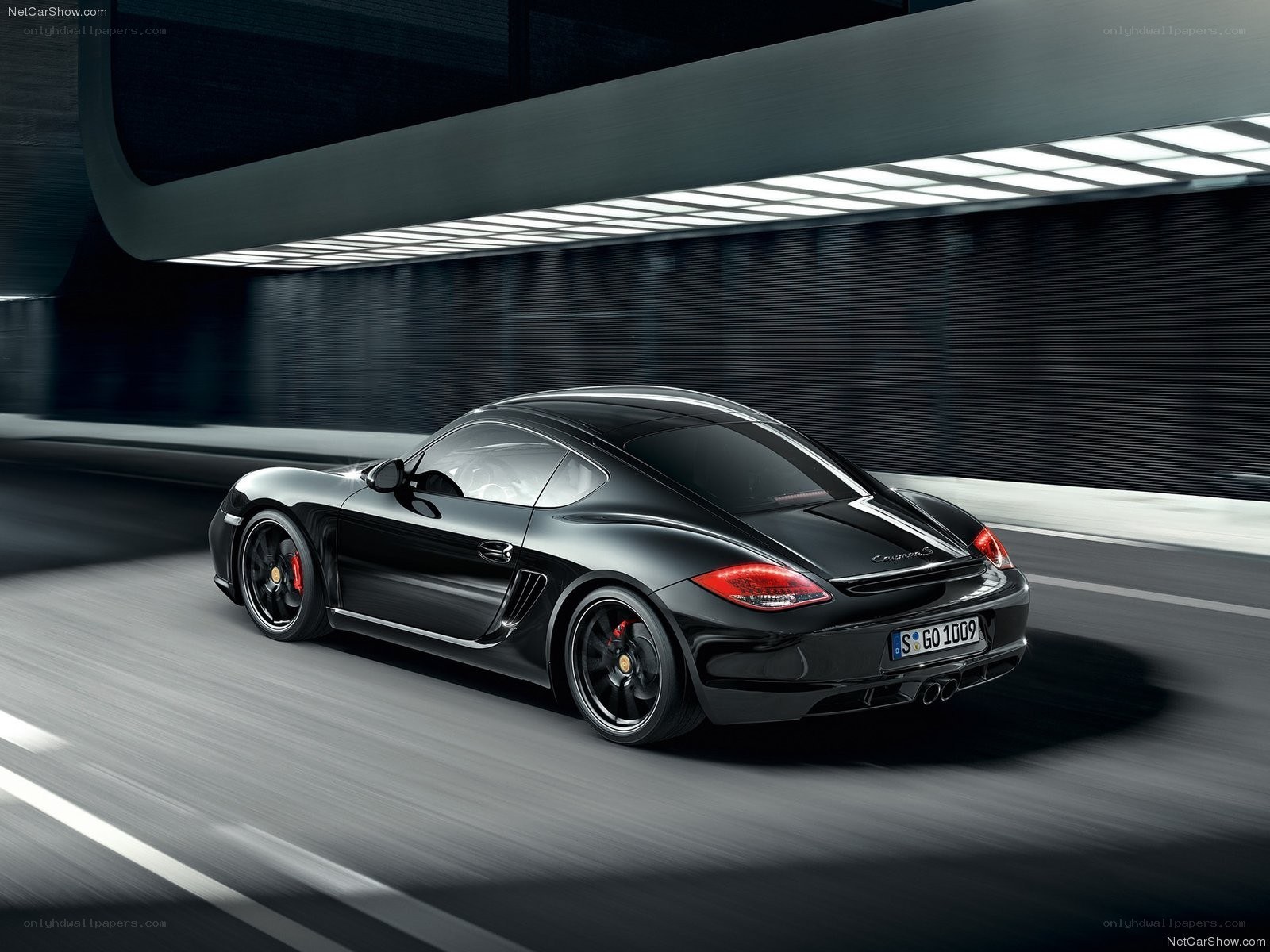 Black Porsche Cayman S in motion