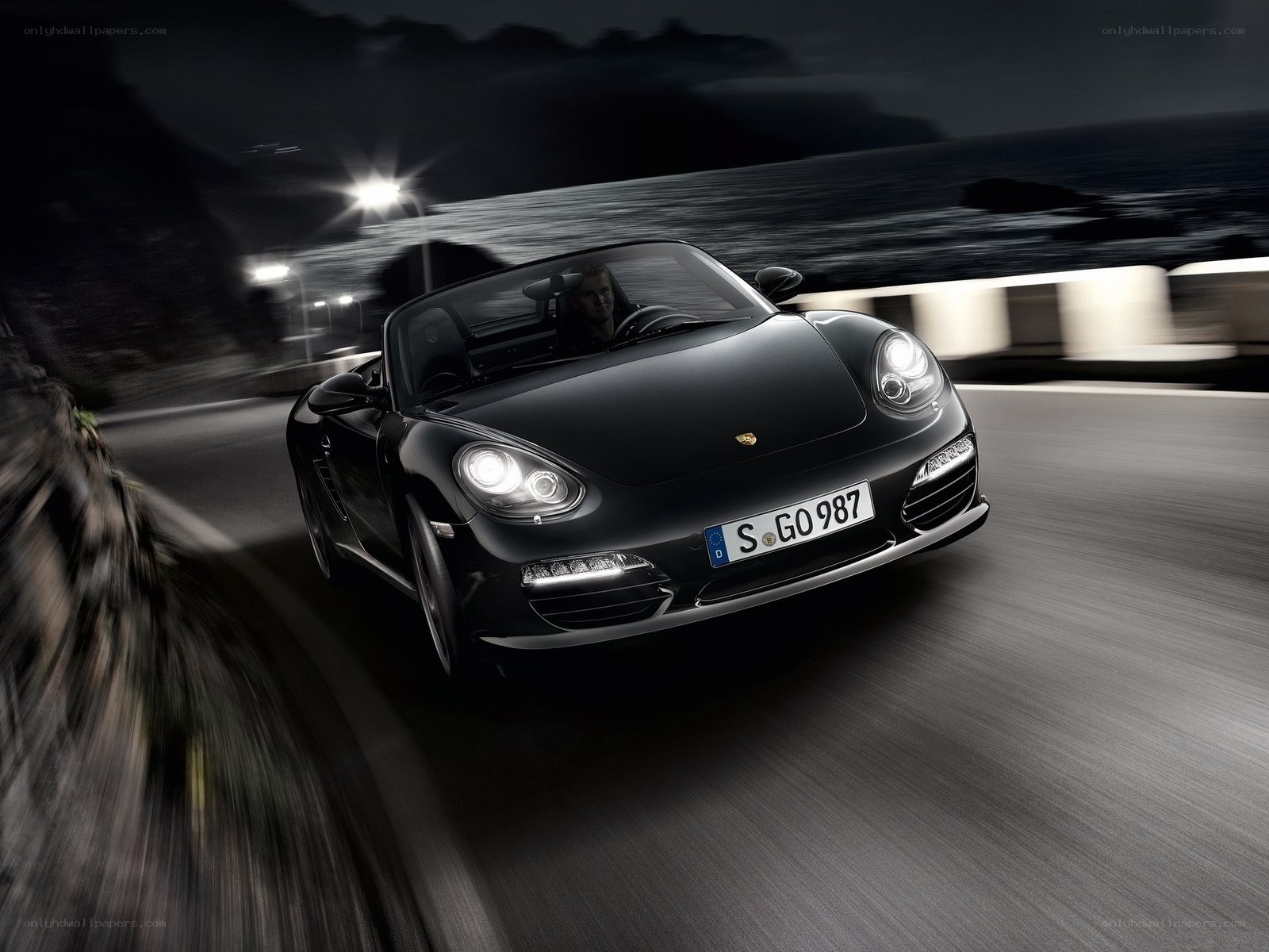 Black Porsche convertible at night