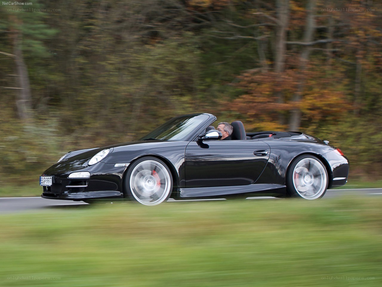Black Porsche convertible in motion