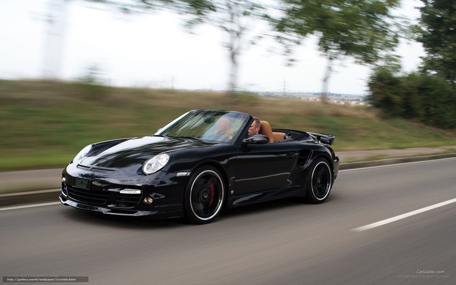 black porsche convertible in motion