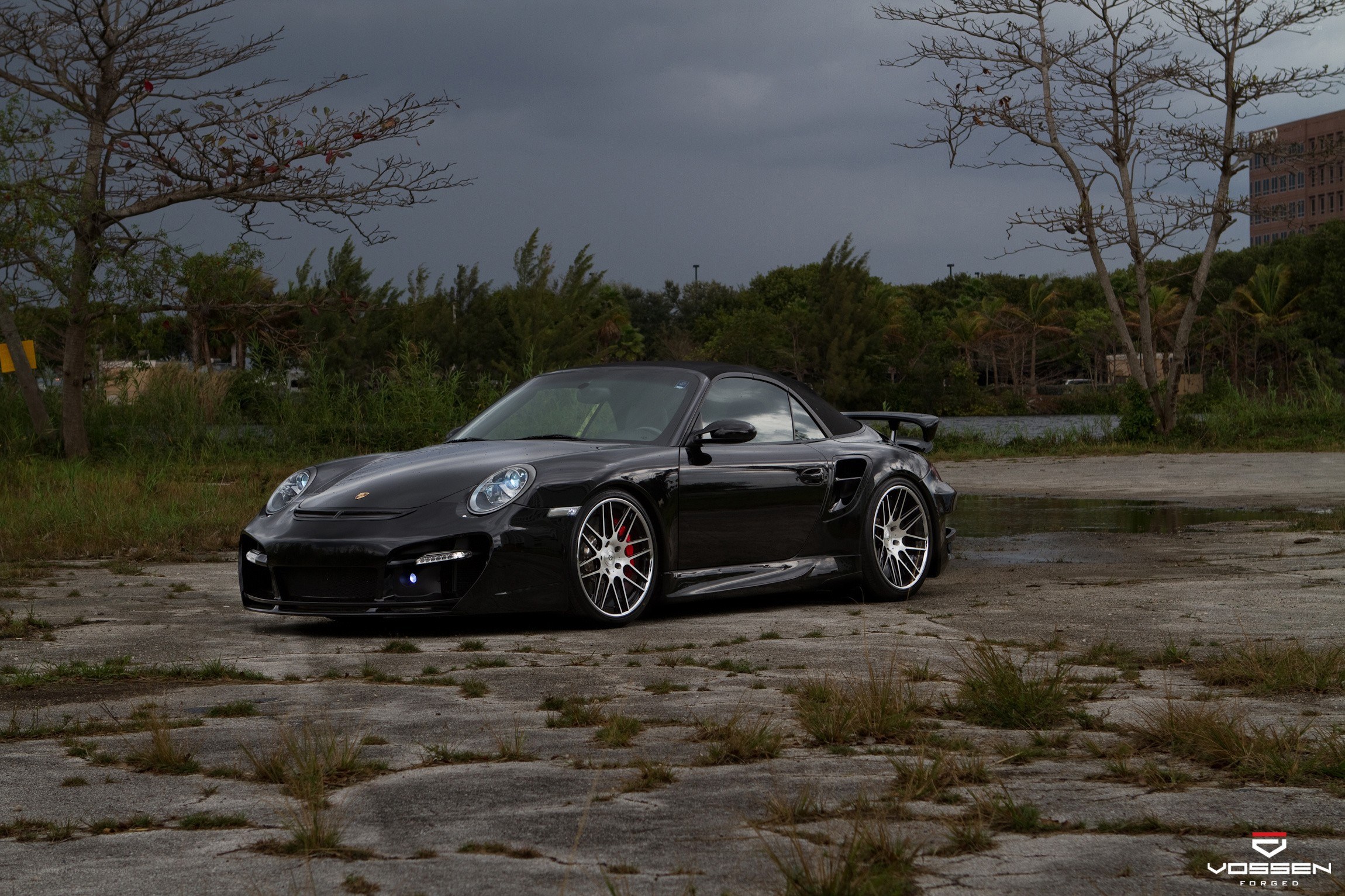 Black Porsche convertible on pavement