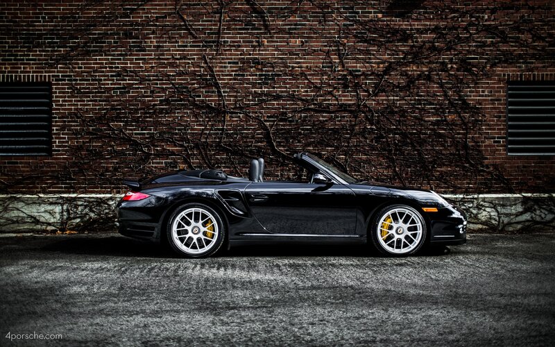Black Porsche convertible on street