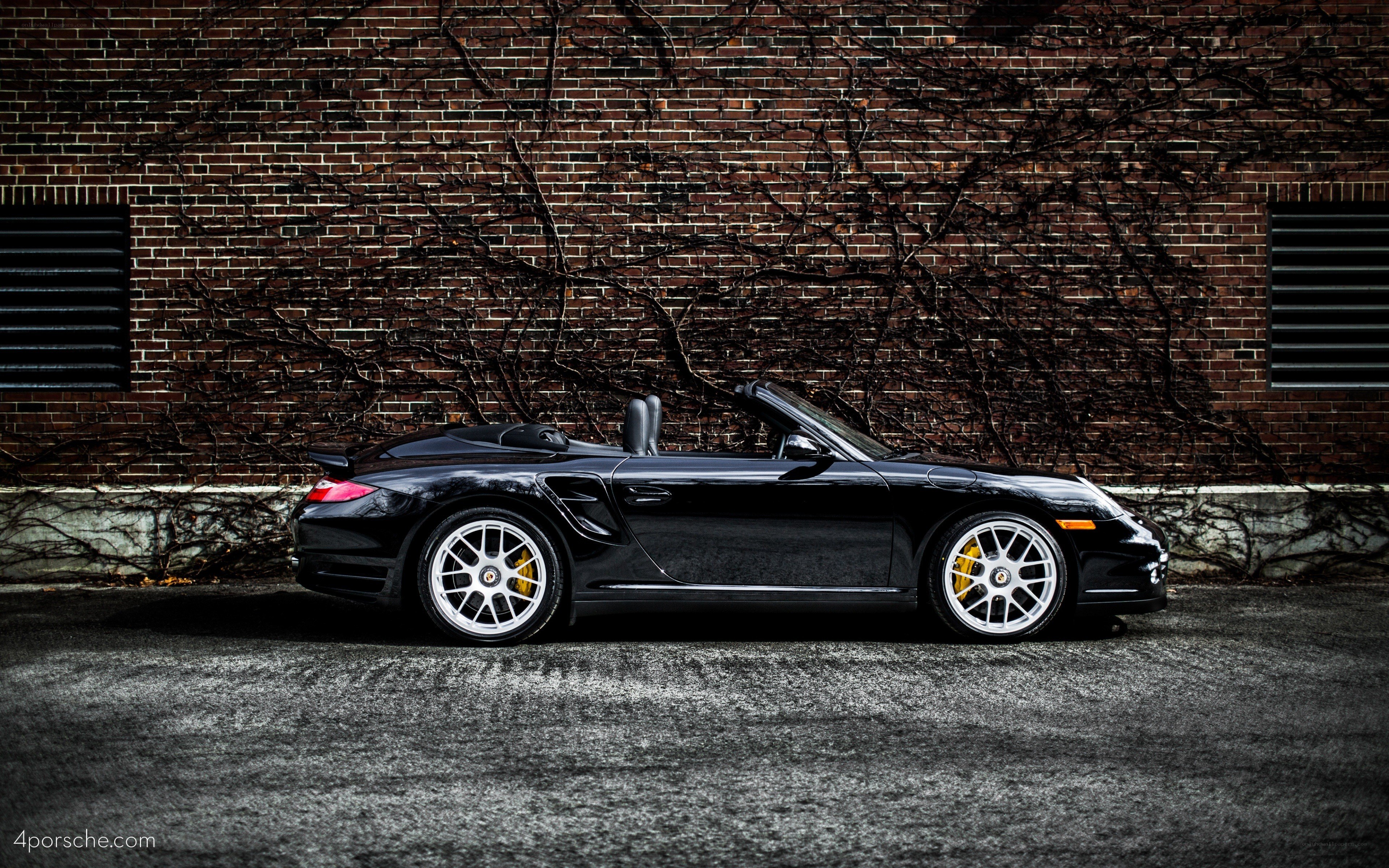 Black Porsche convertible on street