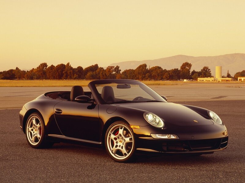 Black Porsche convertible on tarmac