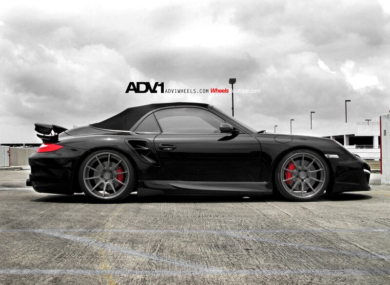 Black Porsche convertible with custom wheels