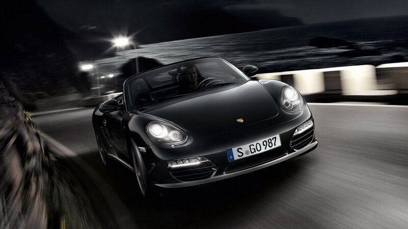 Black Porsche driving at night