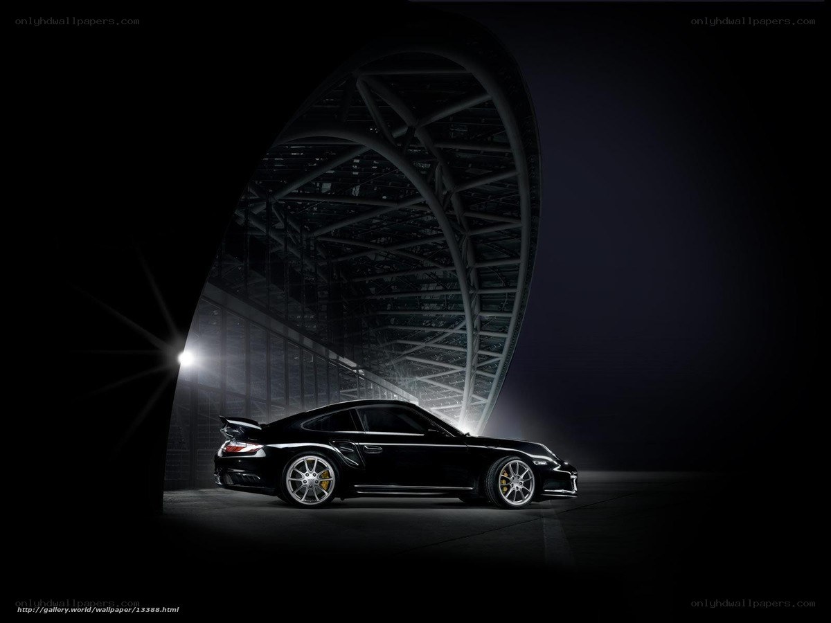 Black Porsche in a dark hangar
