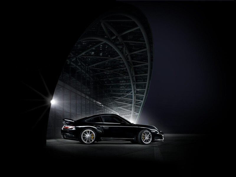Black Porsche in a dark hangar
