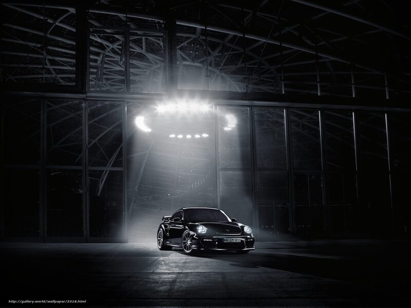 Black Porsche in a dark hangar