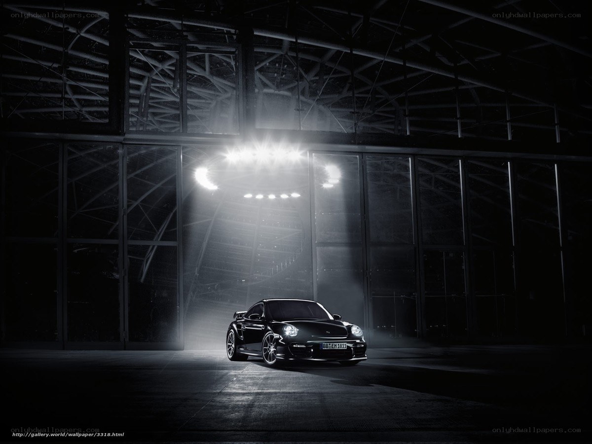 Black Porsche in a dark hangar