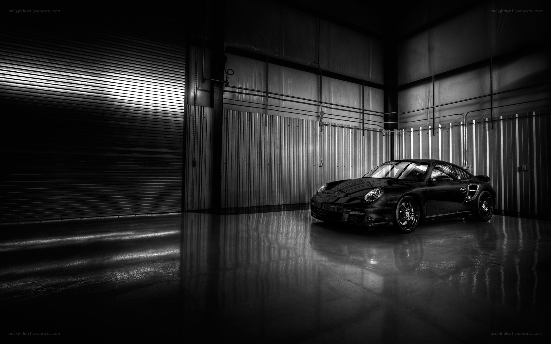 Black Porsche in a warehouse