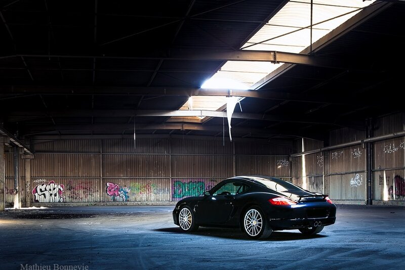 Black Porsche in an abandoned warehouse