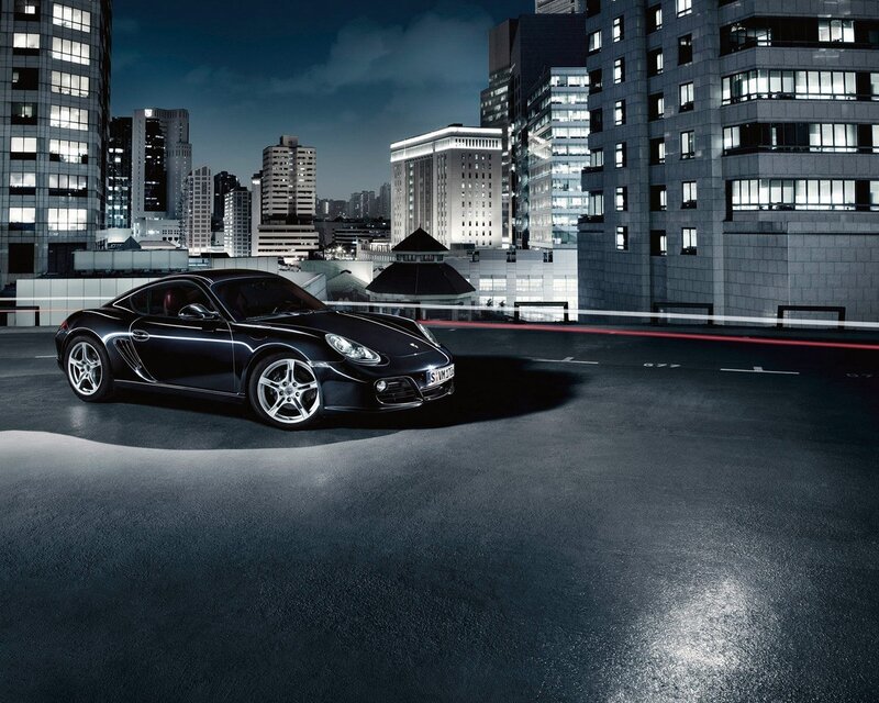 Black Porsche in city at night