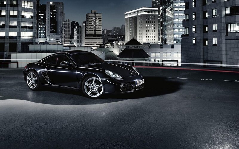 Black Porsche in city at night