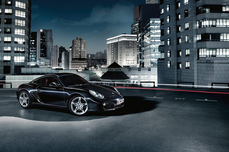 Black Porsche in city at night