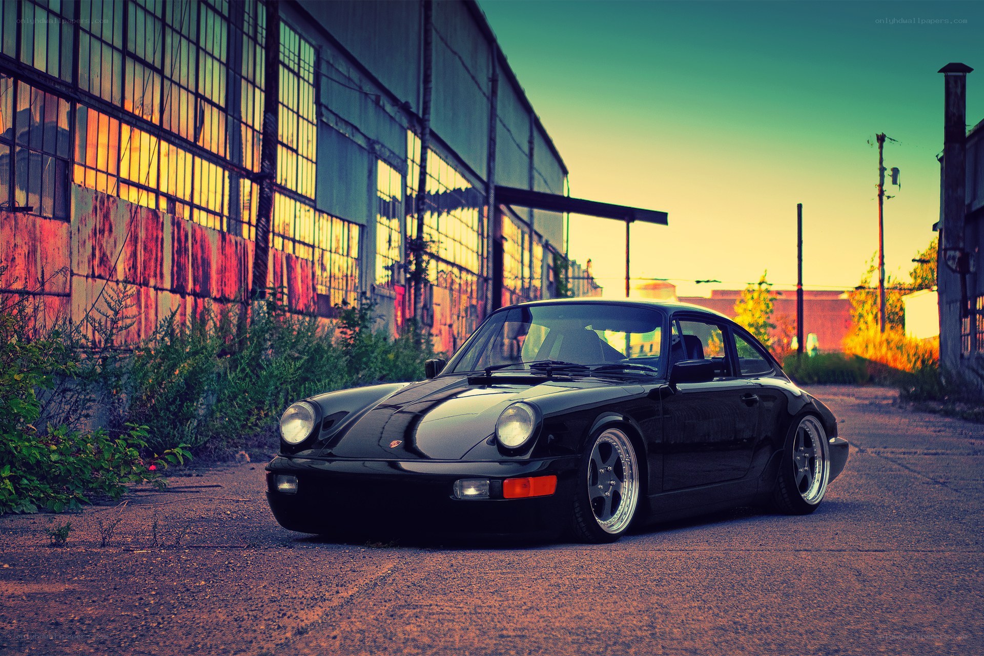Black Porsche in industrial setting