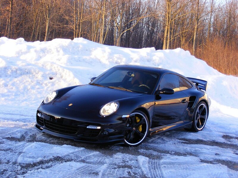 Black Porsche in snowy landscape