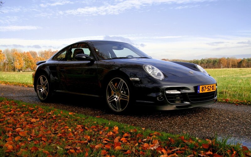 Black Porsche on a country road