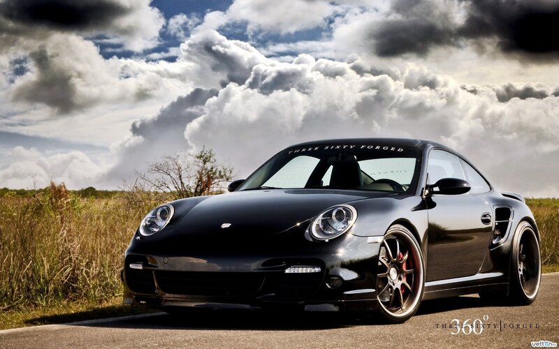 Black Porsche on a country road