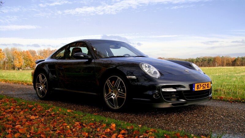 Black Porsche on a country road