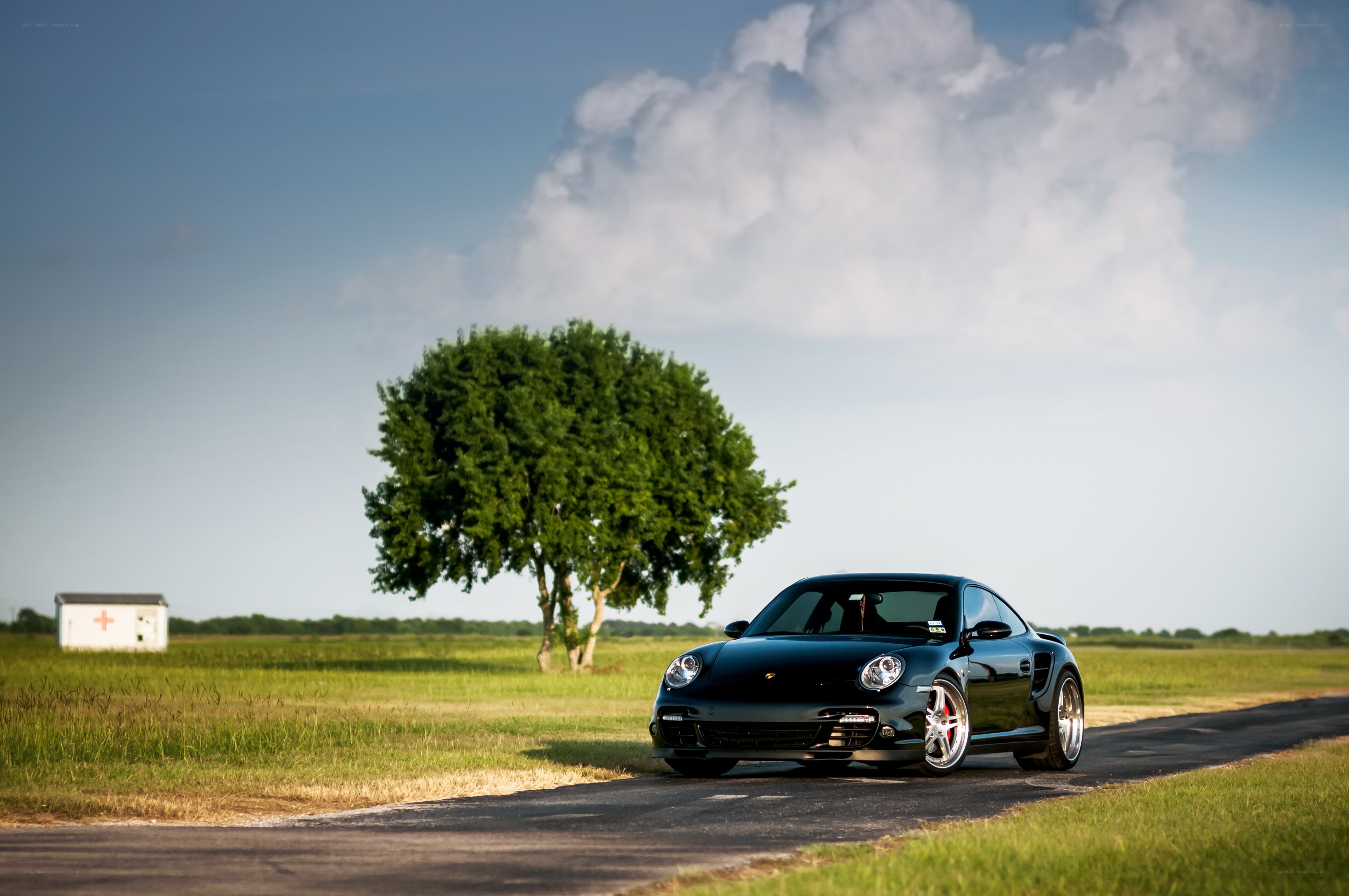 Black Porsche on a country road