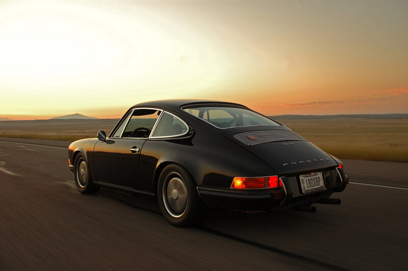 Black Porsche on a desert road