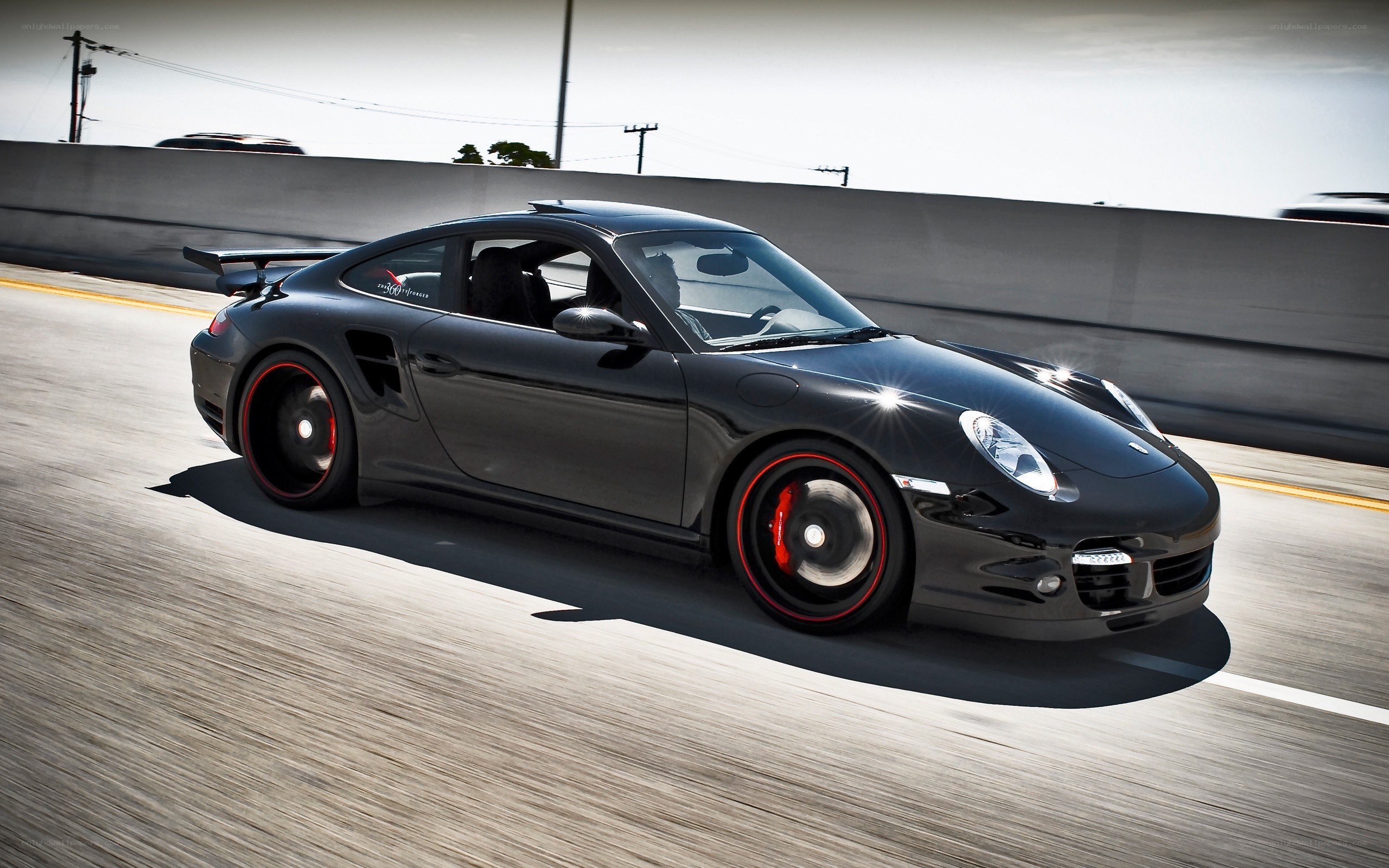 Black Porsche on a highway