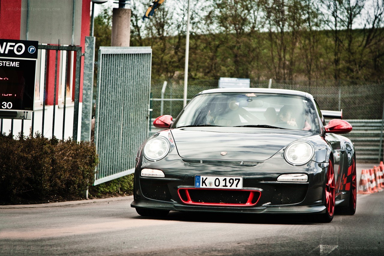 Black Porsche on a racetrack
