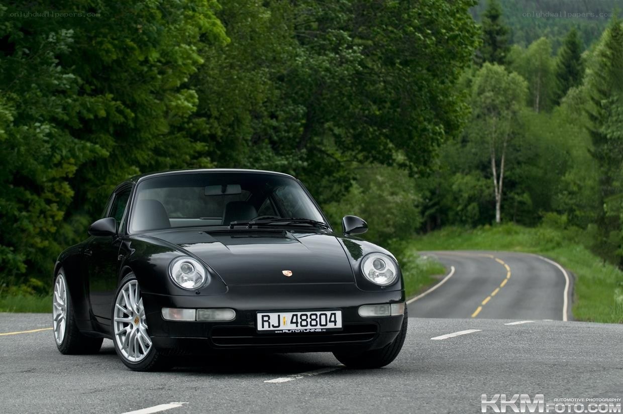 black porsche on a winding road