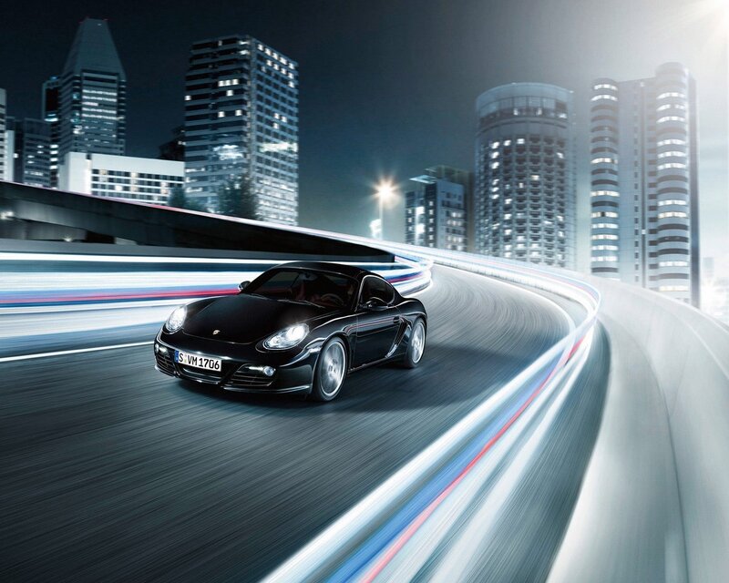 Black Porsche on city highway
