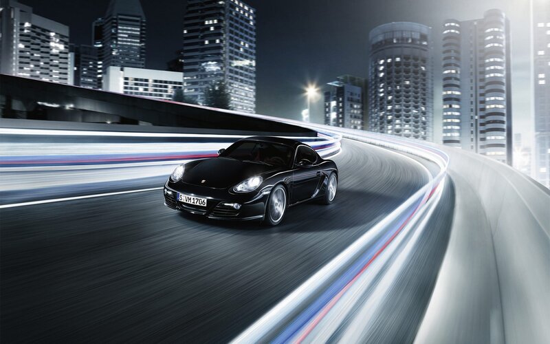 Black Porsche on city highway