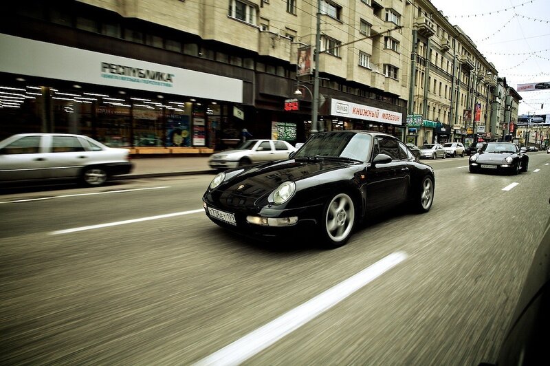 Black Porsche on city street