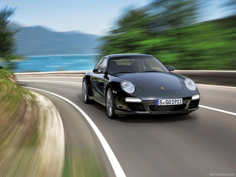 Black Porsche on coastal road