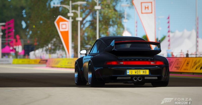 Black Porsche on Racetrack — Dynamic