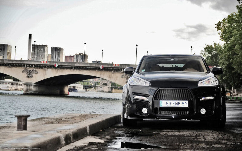Black Porsche on riverbank