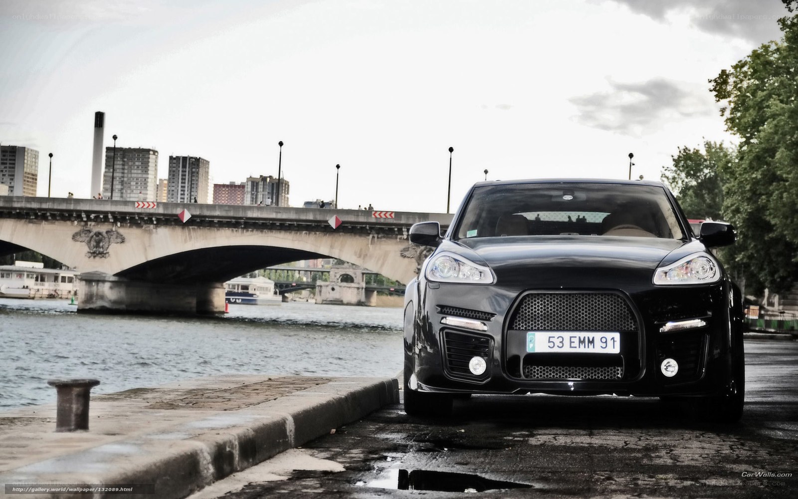 Black Porsche on riverbank