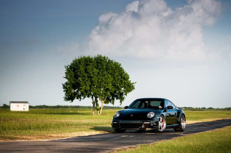 Black Porsche on Road — Green, Serene, Afternoon, Photograph