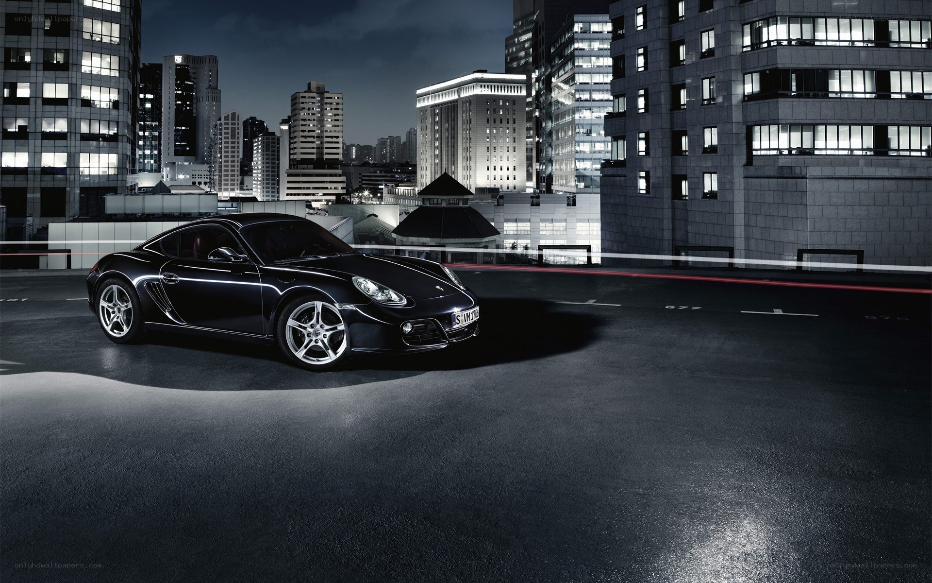 Black Porsche on rooftop at night