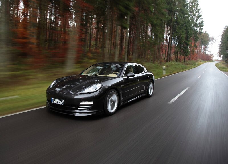 Black Porsche Panamera on forest road