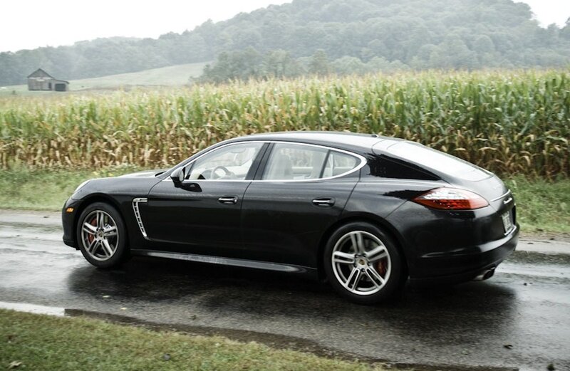 Black Porsche Panamera on wet road